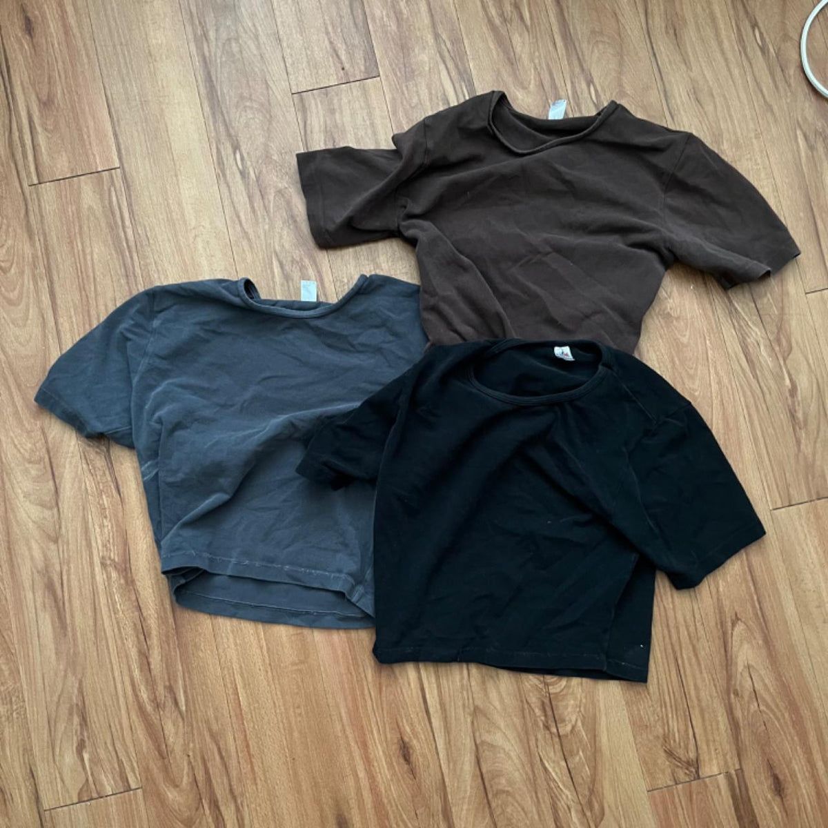 Four black cropped t-shirts